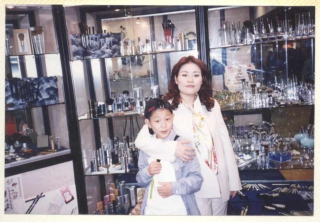 Team 1 Leader Michelle with Brian in front of the Baosheng display cases at Cosmoprof, Bologna, 2001